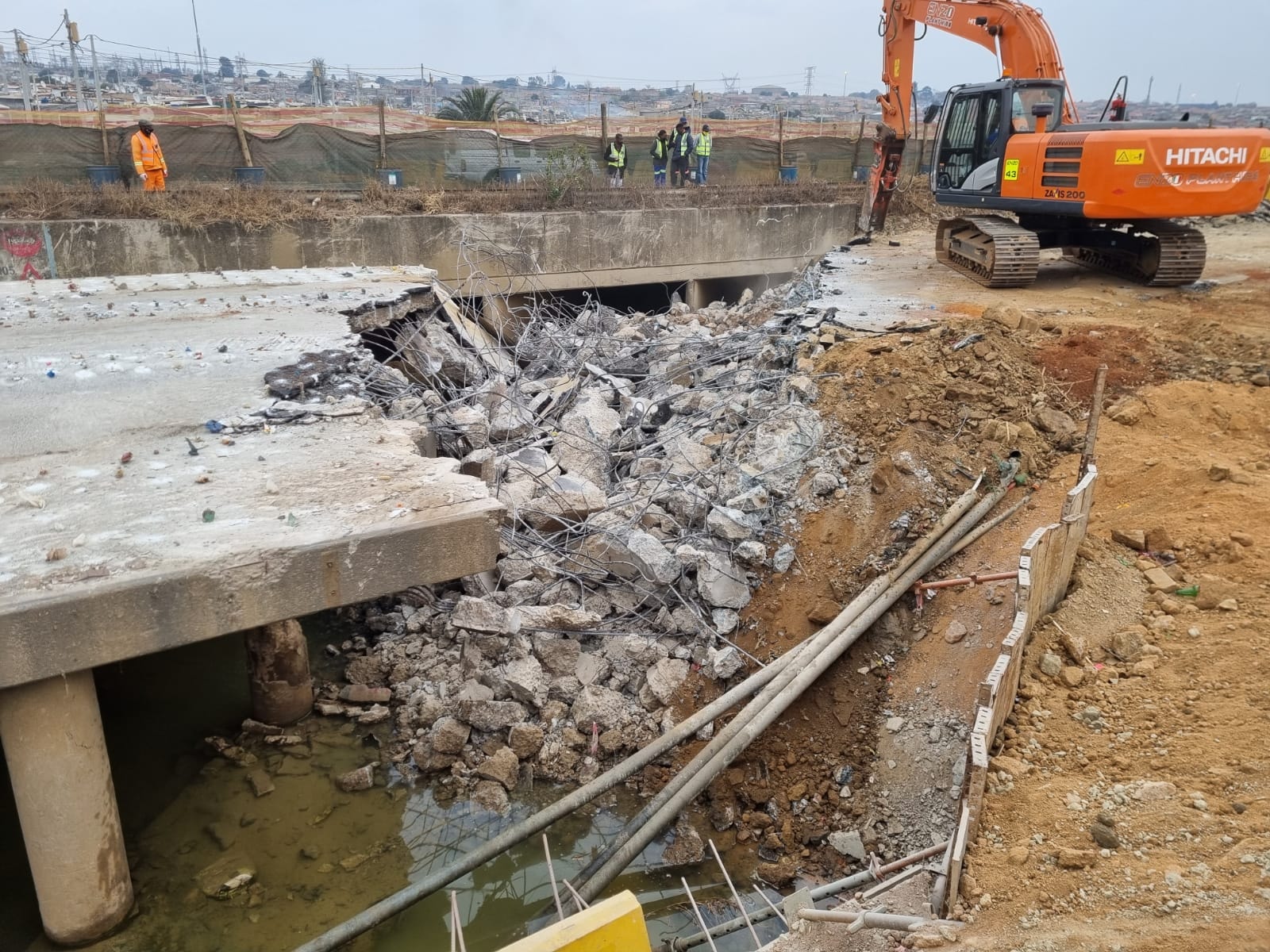 Construction site excavator demolishing concrete