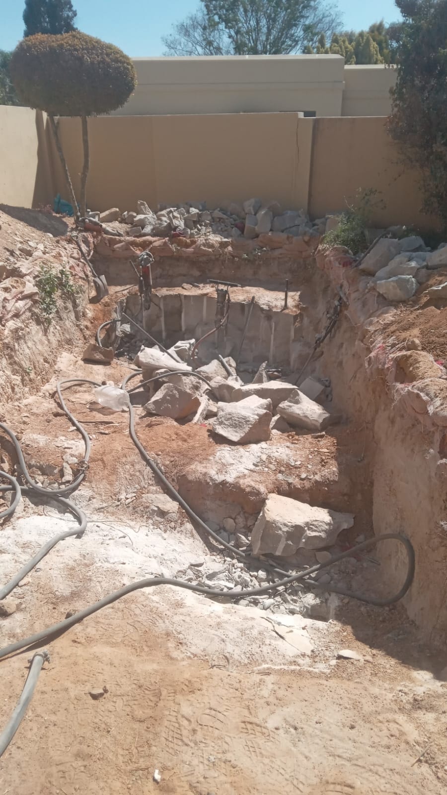 Swimming pool rock excavation site