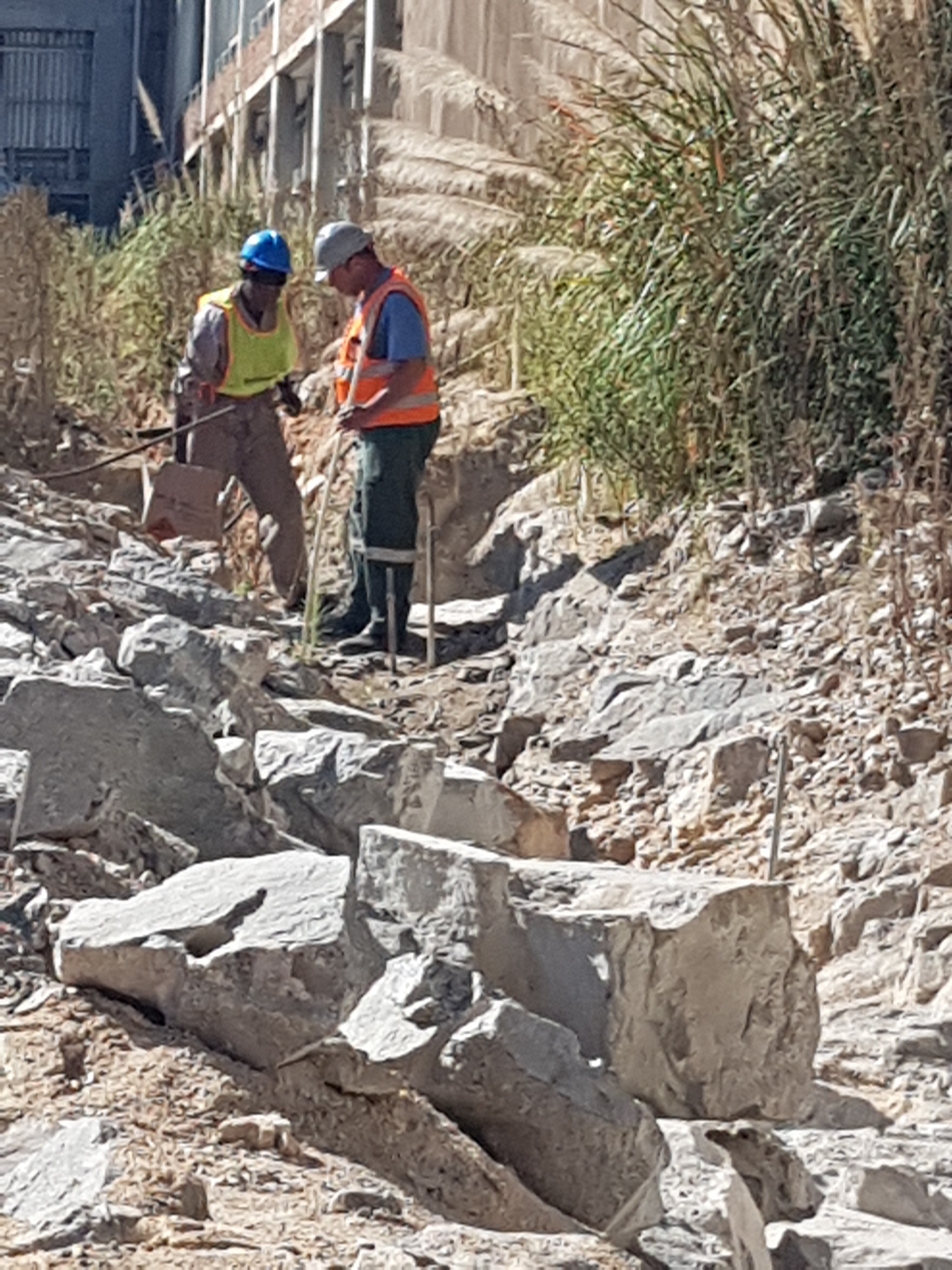 Active Blasting crew assessing blasted rock face on a restricted blasting project